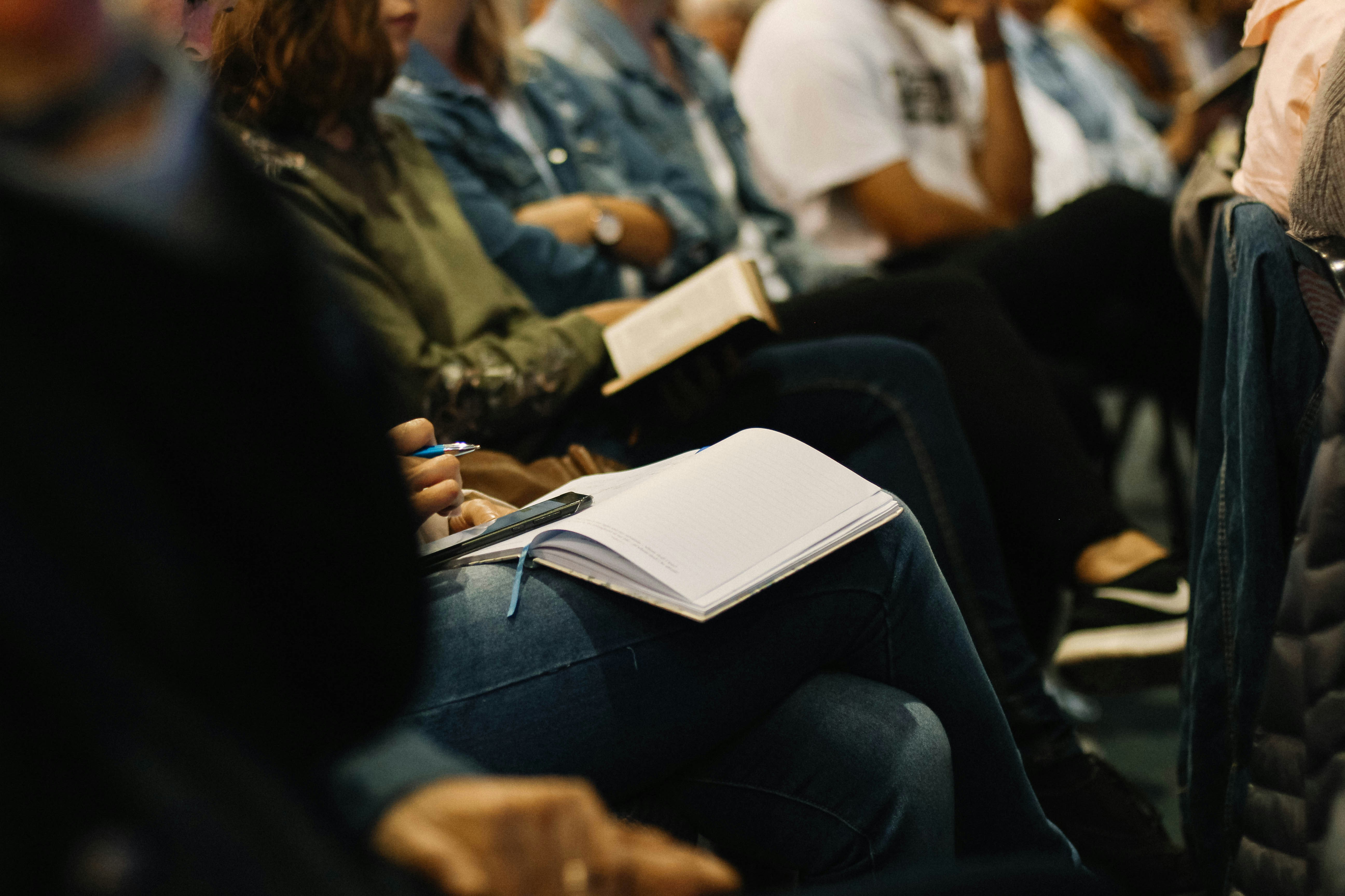 People in a seminar with notebooks open