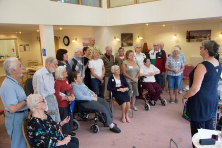  agroup of older people gathered together in a choir