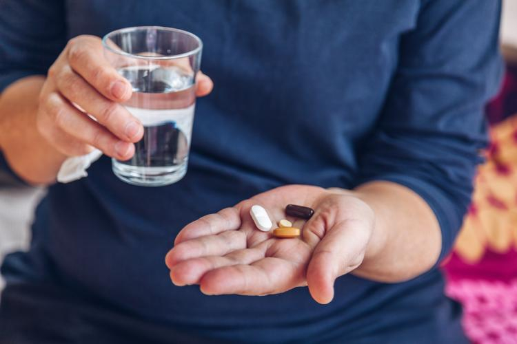 man with drugs in palm of his hand